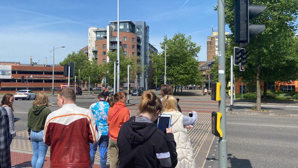A group of young people crossing the road in central Swansea on a sunny day