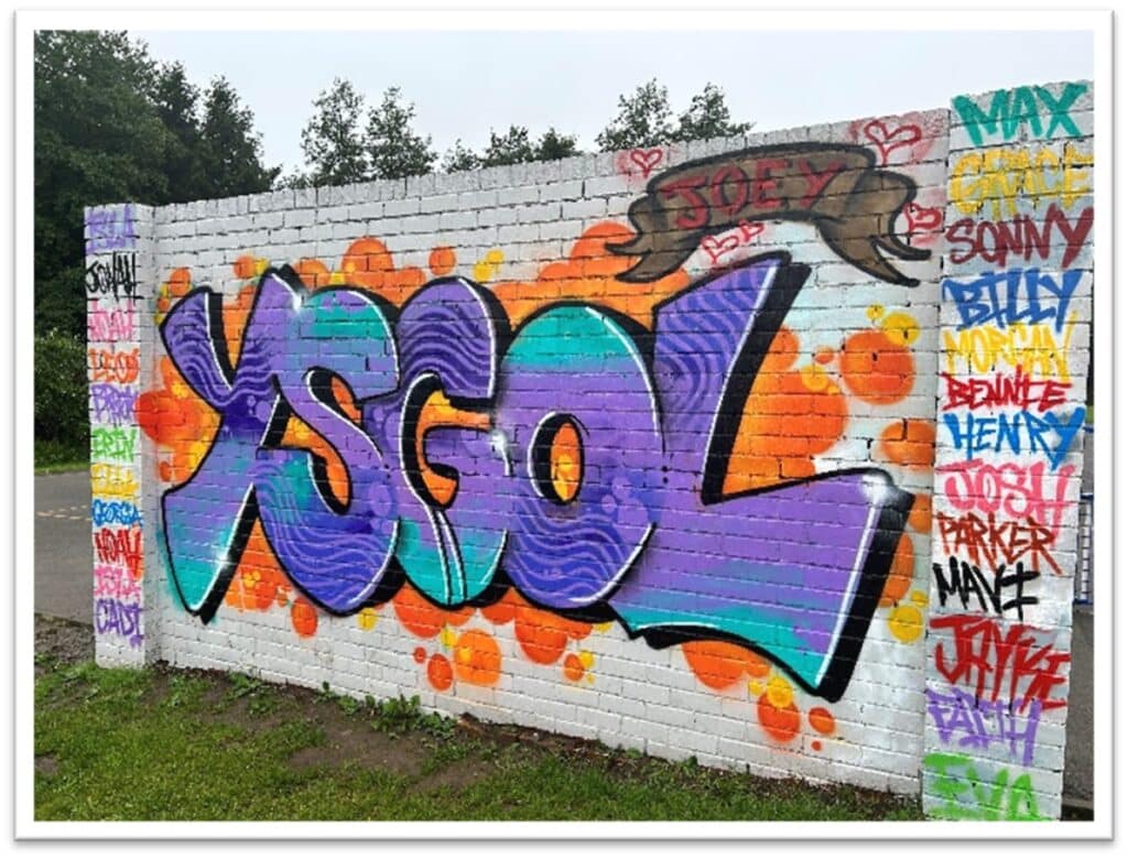 The word Ysgol (meaning school) painted as a mural on the Dunvant Primary School wall.